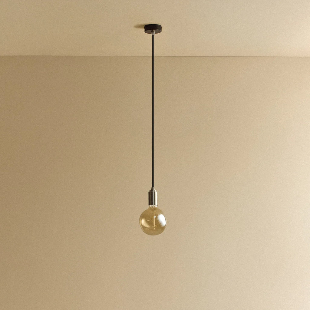Tinted globe bulb pendant, in stainless steel, lit