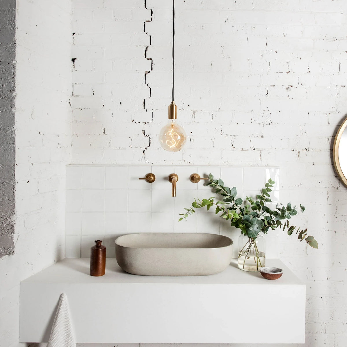 Tinted globe bulb plug-in pendant, above a bathroom basin