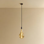 Large tinted teardrop bulb pendant, graphite, lit, against a plain wall