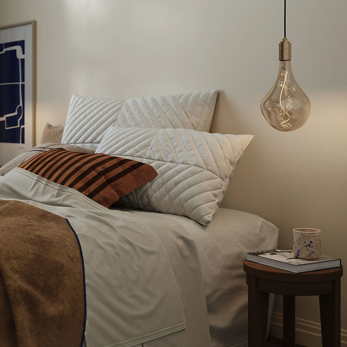 Tinted teardrop bulb plug-in pendant, beside a bed