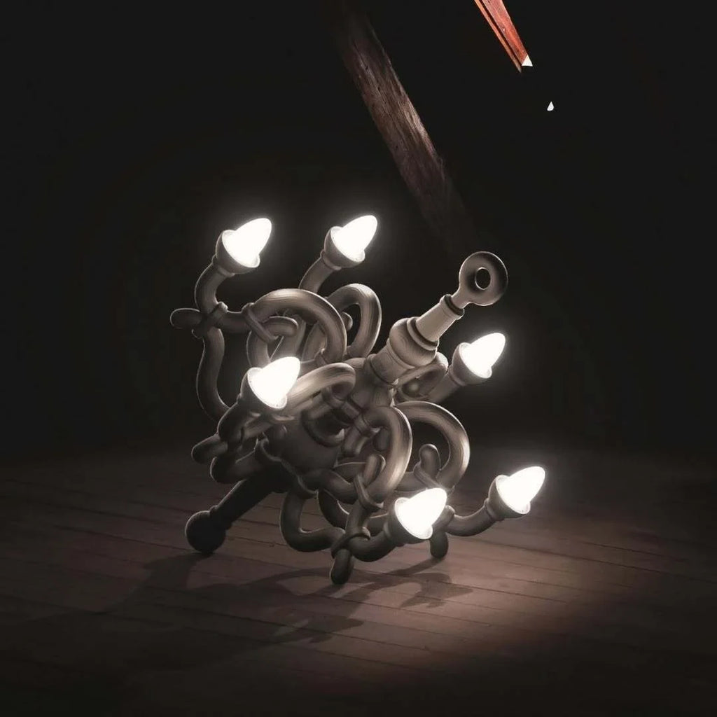 Toppled chandelier cordless lamp, black, lit in a dark room