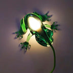 Translucent frog table lamp, in green, glowing against a wall