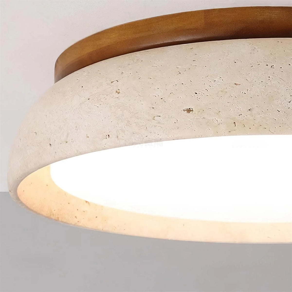 Travertine and wood flush ceiling light, close-up of the travertine