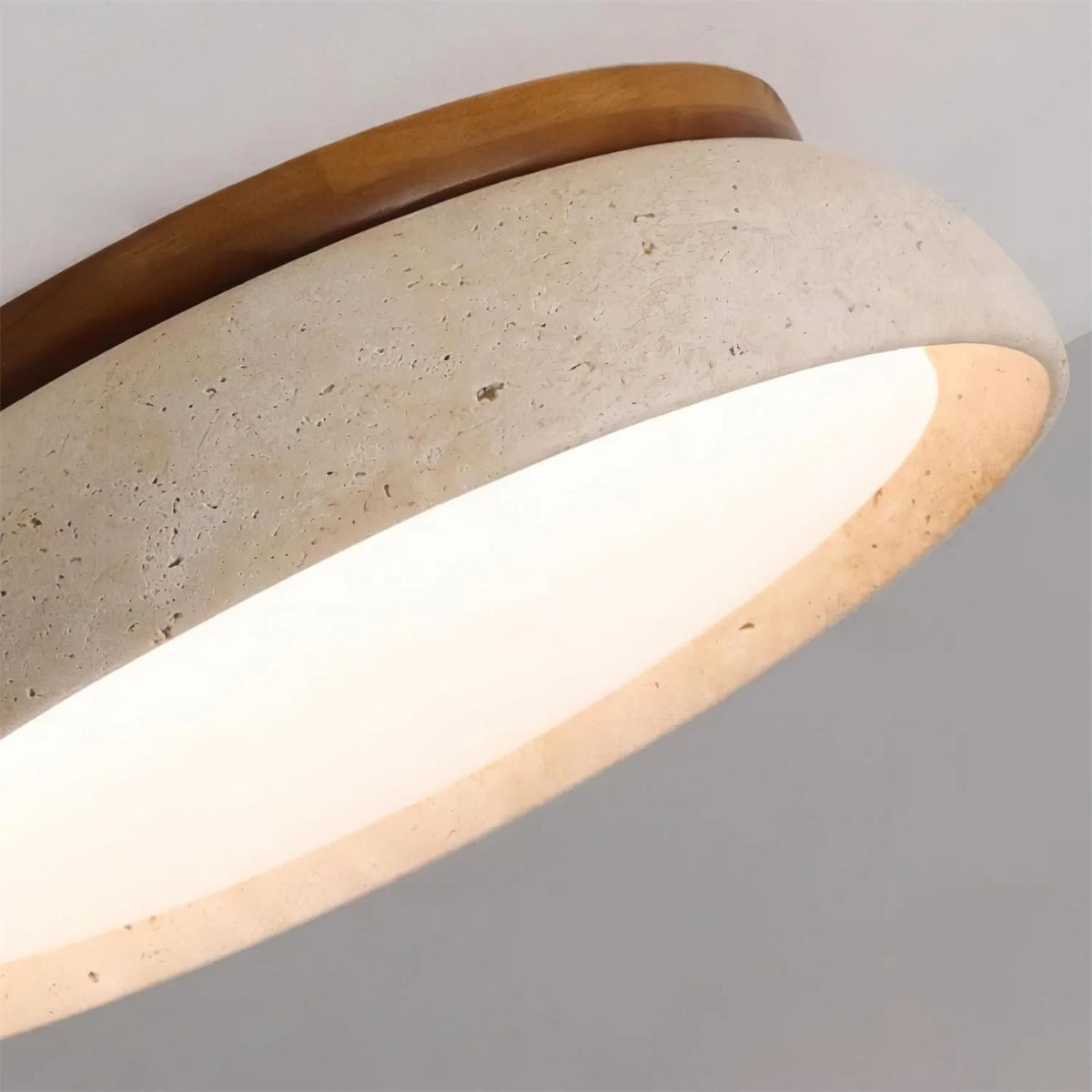 Travertine and wood flush ceiling light, close-up of the edge