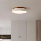 Travertine and wood flush ceiling light, lit on a ceiling