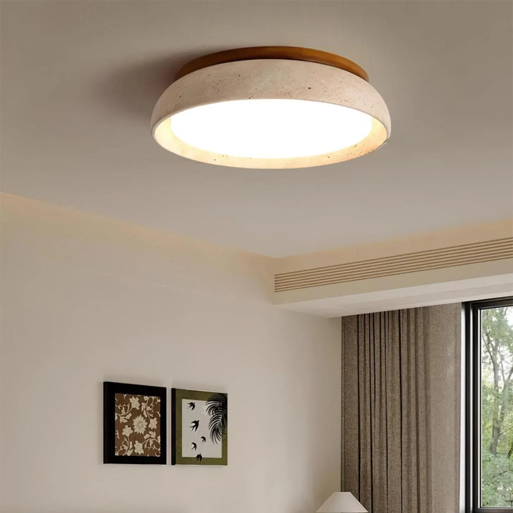 Travertine and wood flush ceiling light, lit on a ceiling