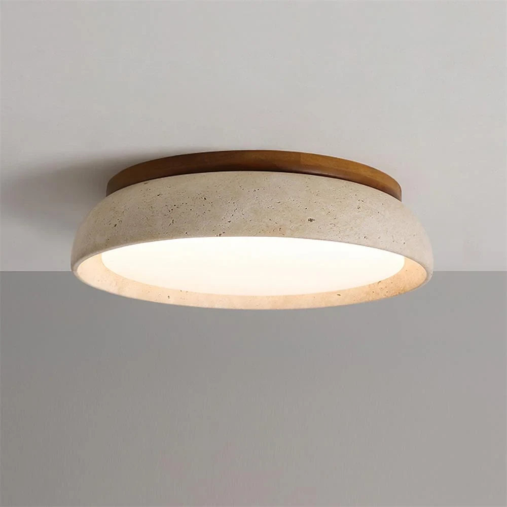 Travertine and wood flush ceiling light, lit on a ceiling