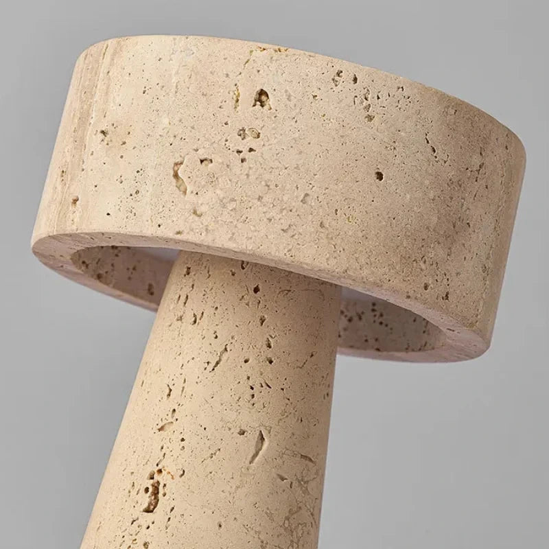 Close-up of the travertine cap and column showing the stone's natural pores