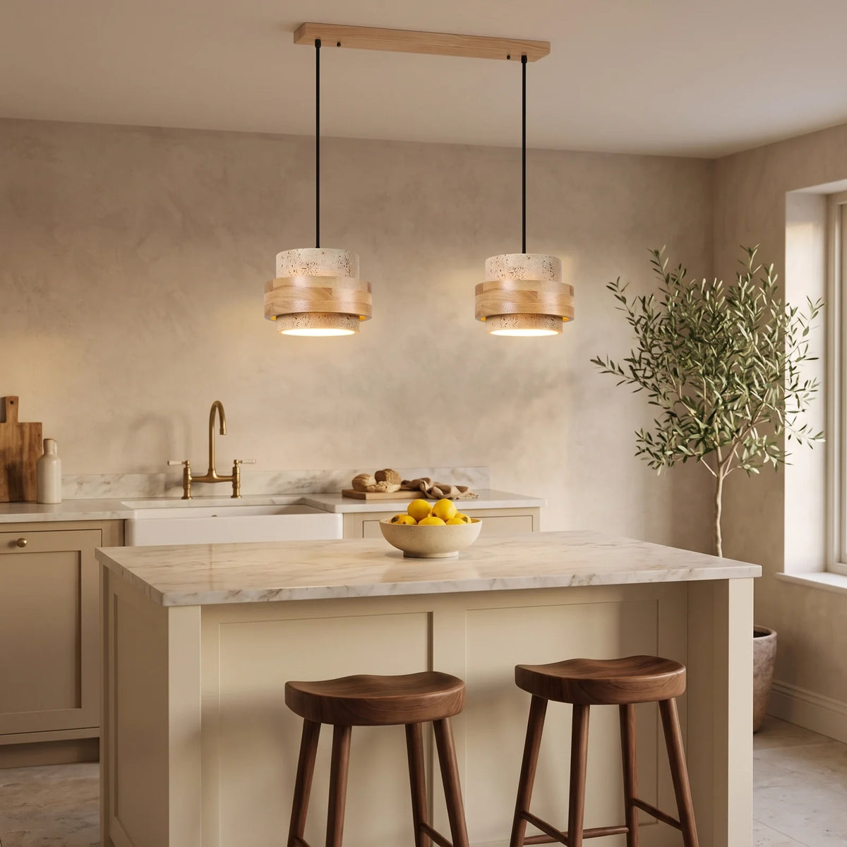 Two natural travertine and oak drum pendants over a kitchen island