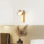 Travertine and wood wall light, lit above a shelf