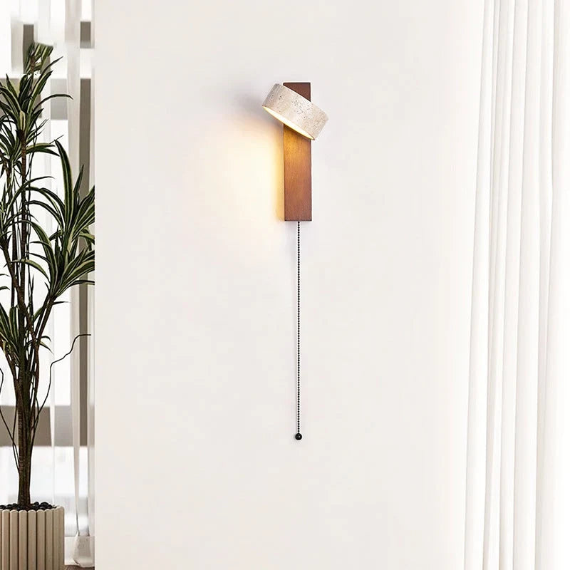 Travertine and wood wall light, with its cable on a wall