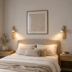 Travertine and wood wall light, a pair lit beside a bed