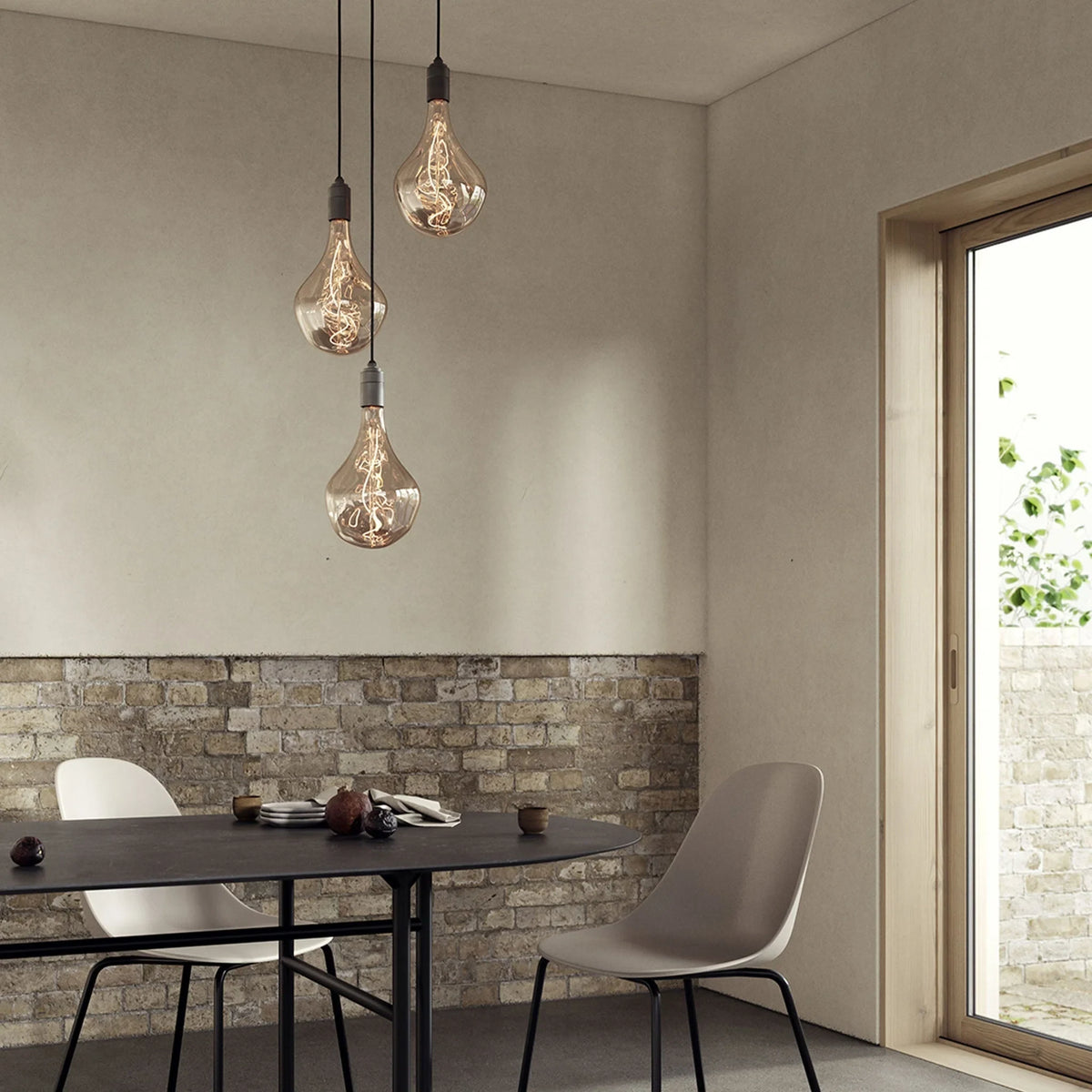 Triple Cluster Bulb Holder Pendant, shown with tinted decorative bulbs (not included) above a dining table