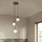 Triple Cluster Bulb Holder Pendant, shown with opal globe bulbs (not included) above a dining table