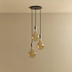 Triple cluster pendant with tinted sculptural bulbs, unlit