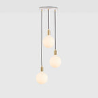 Triple opal sphere cluster pendant, with white canopy on a grey background