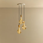 Triple Tinted Bulb Cluster Pendant, in oak, lit, against a plain wall