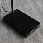 Twin-head adjustable table lamp, close-up of the black marble base