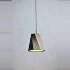 Twisted concrete pendant, against a concrete wall