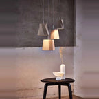 Twisted concrete pendant, a group above a side table
