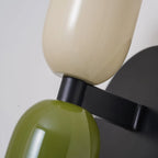 Two-tone up and down wall light, close-up in beige and green