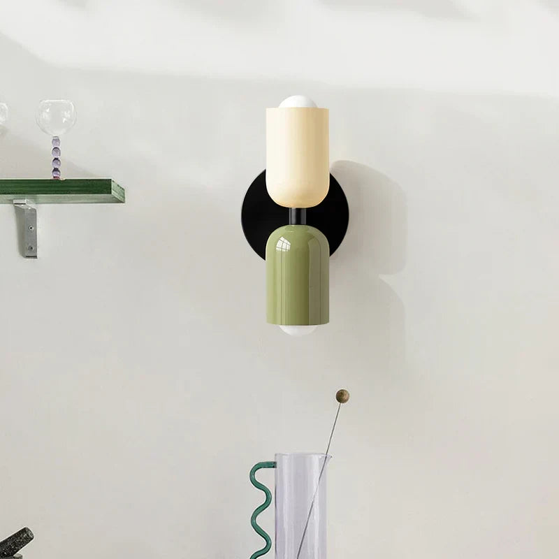 Two-tone up and down wall light, in beige and green on a white wall