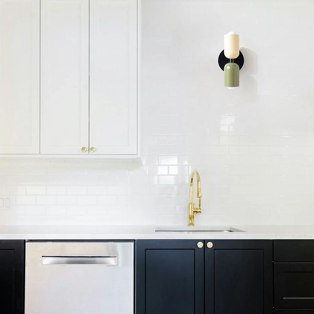 Two-tone up and down wall light, in beige and black in a kitchen