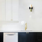Two-tone up and down wall light, in beige and black in a kitchen