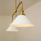 Two-light gold bar pendant with white cone shades, in a room