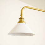Two-light gold bar pendant with white cone shades, in a room