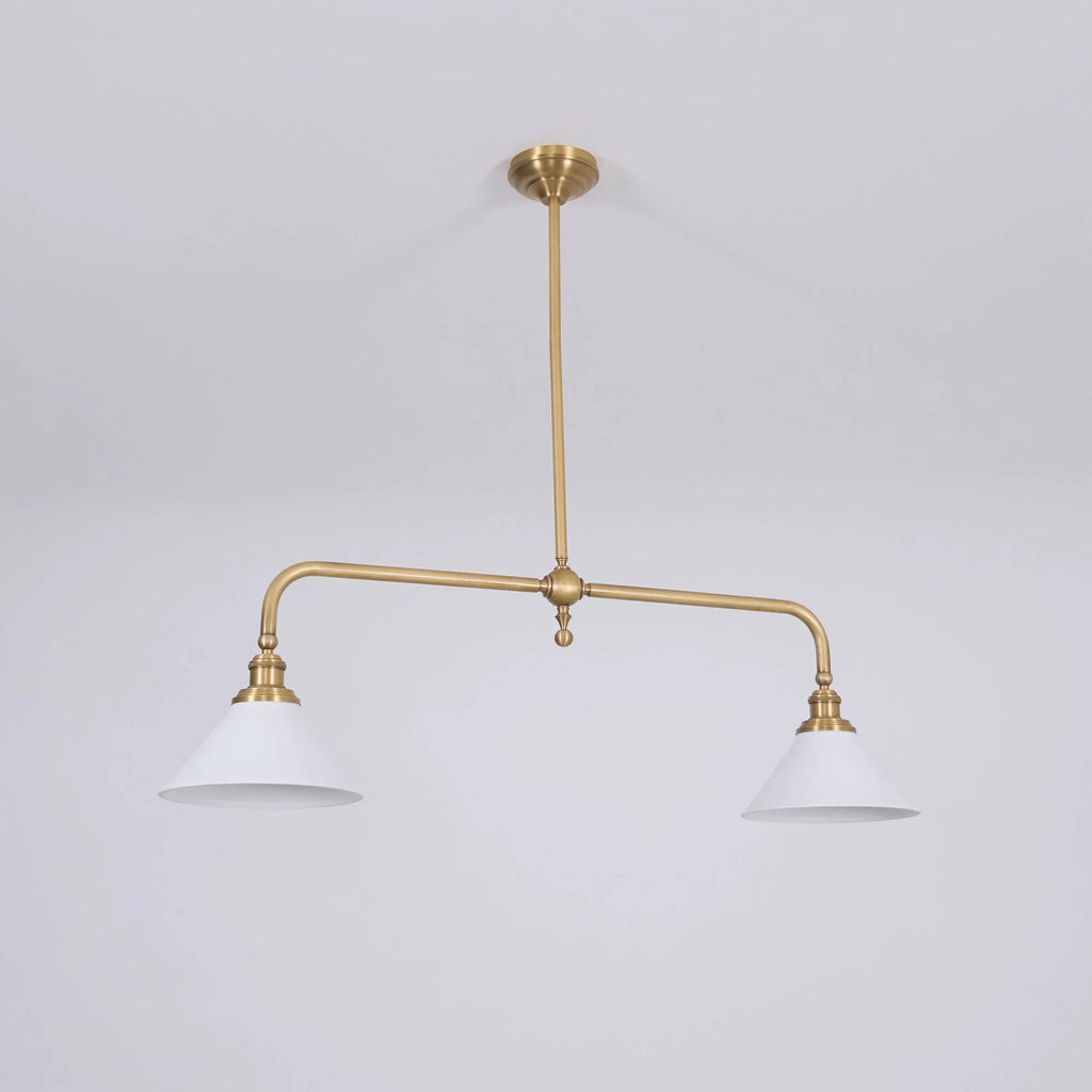 Two-light gold bar pendant with white cone shades, in a room
