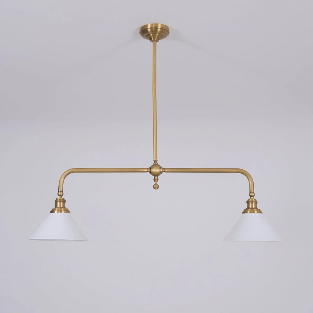 Two-light gold bar pendant with white cone shades, in a room