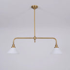 Two-light gold bar pendant with white cone shades, in a room
