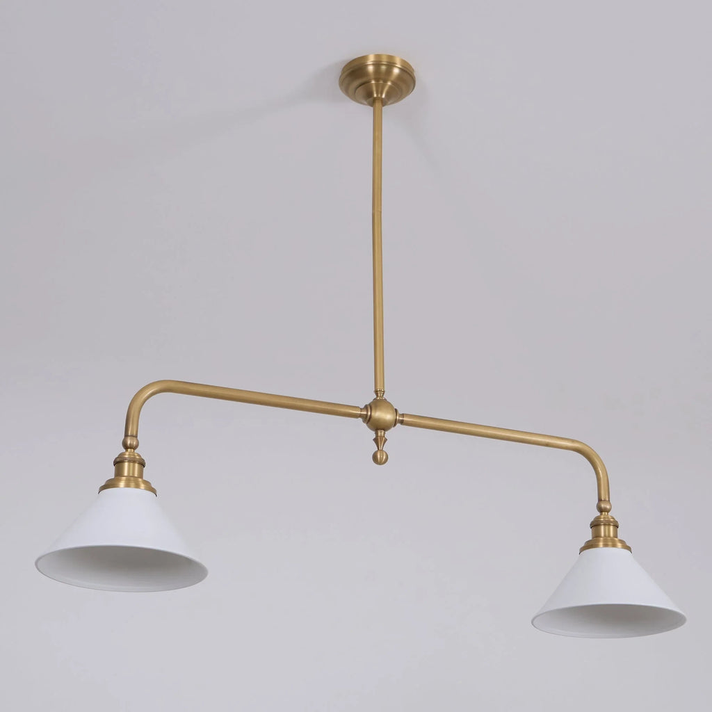 Two-light gold bar pendant with white cone shades, in a room