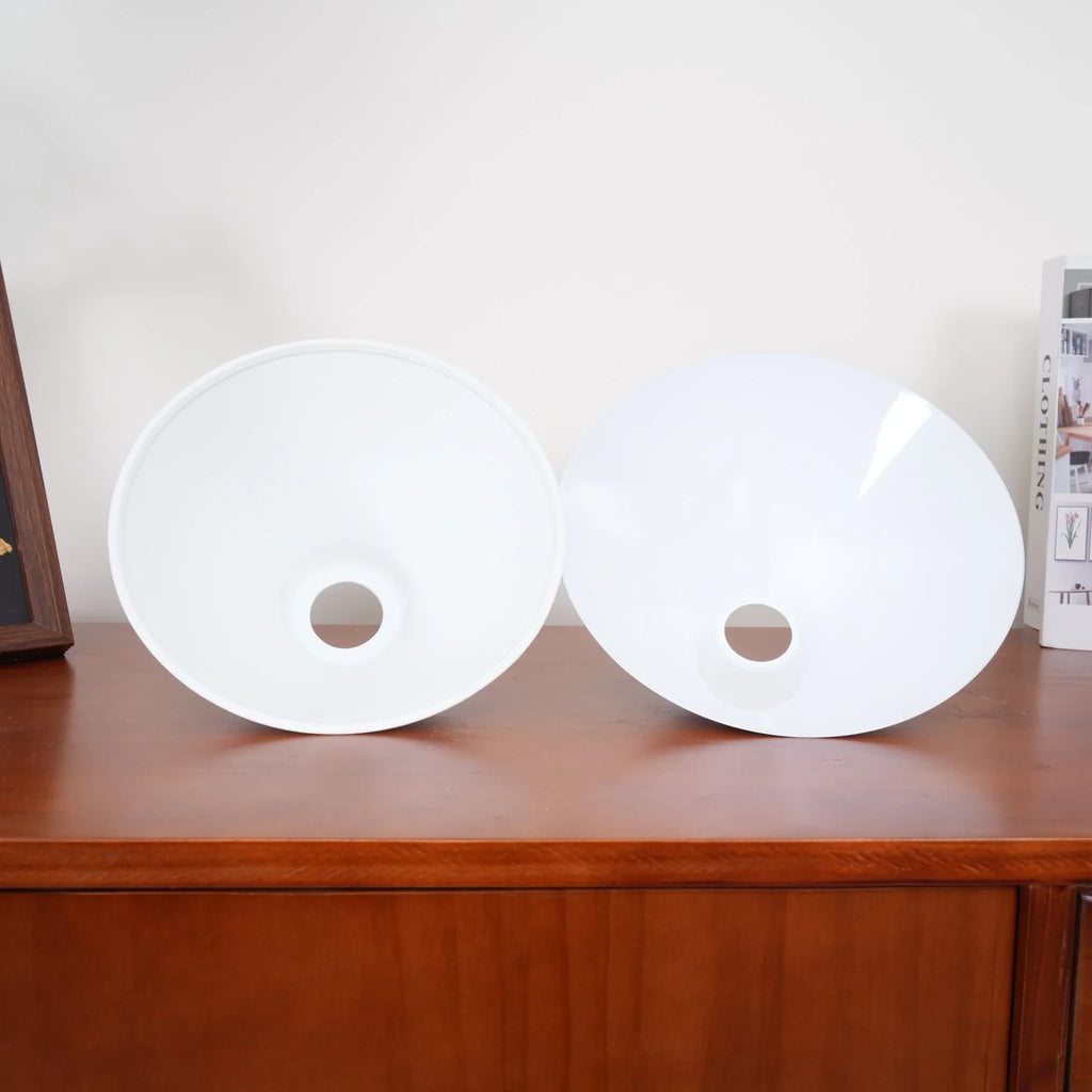 Two-light gold bar pendant with white cone shades, spare shades on a sideboard