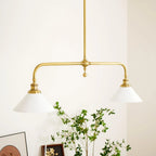 Two-light gold bar pendant with white cone shades, in a room