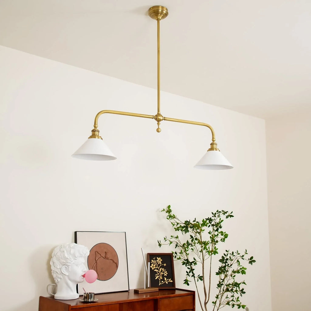 Two-light gold bar pendant with white cone shades, in a room