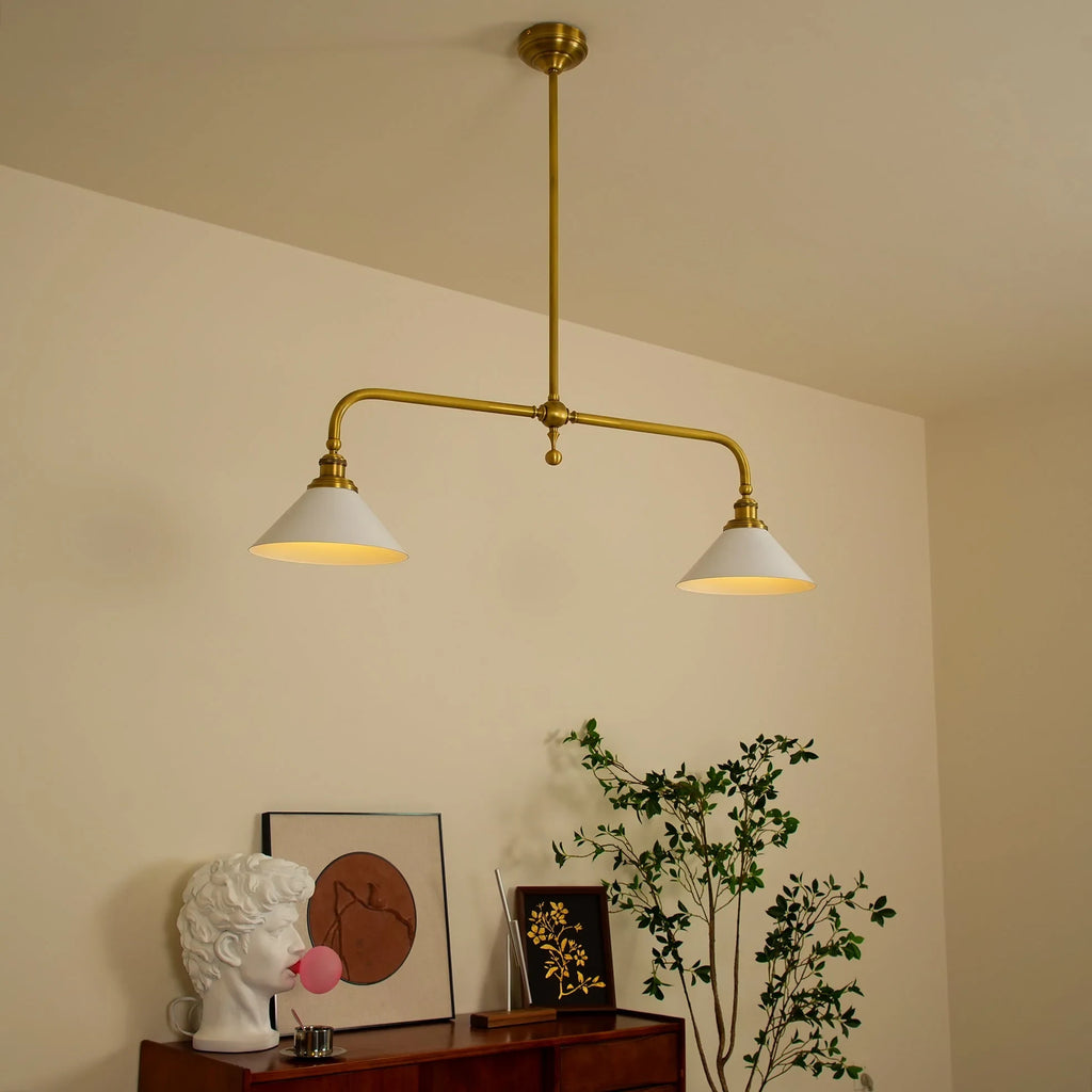 Two-light gold bar pendant with white cone shades, in a room