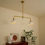 Two-light gold bar pendant with white cone shades, in a room