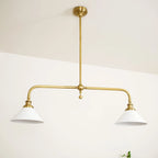 Two-light gold bar pendant with white cone shades, in a room