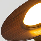 Low profile walnut and gold flush ceiling light, close-up of the lit edge