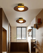 Low profile walnut and gold flush ceiling light, two lit along a hallway
