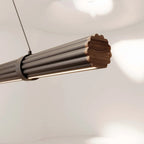 Walnut linear LED pendant, close-up of the walnut and metal end