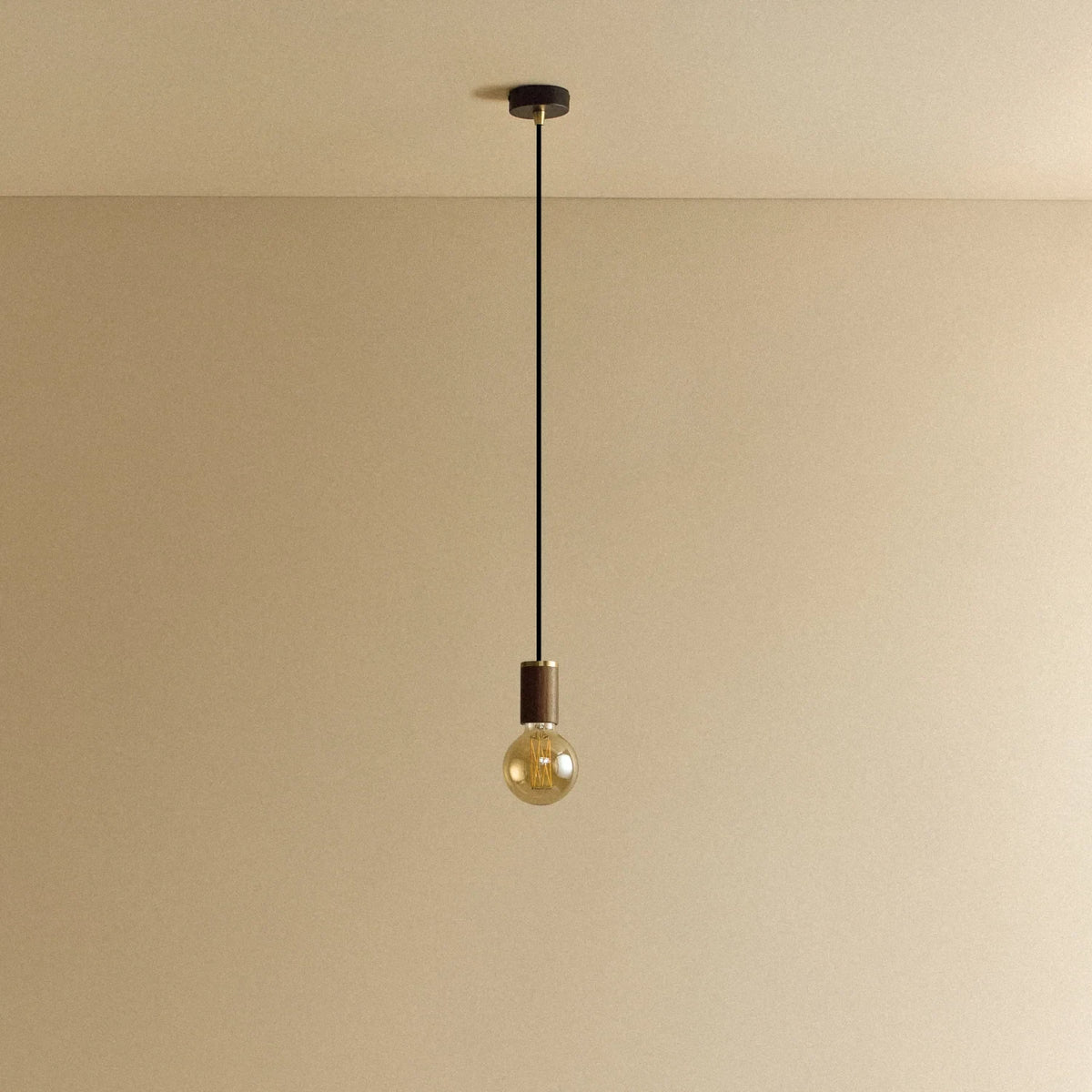 Walnut pendant with tinted glass filament bulb, unlit