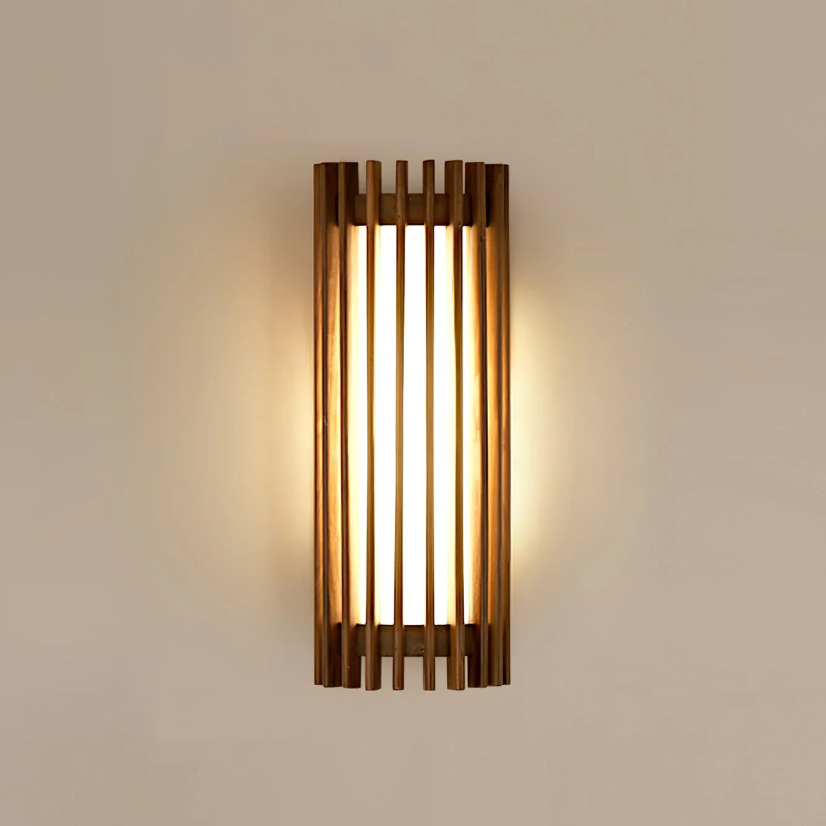 Walnut wood slatted wall light, lit on a plain wall
