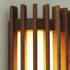 Walnut wood slatted wall light, close-up of the lit slats