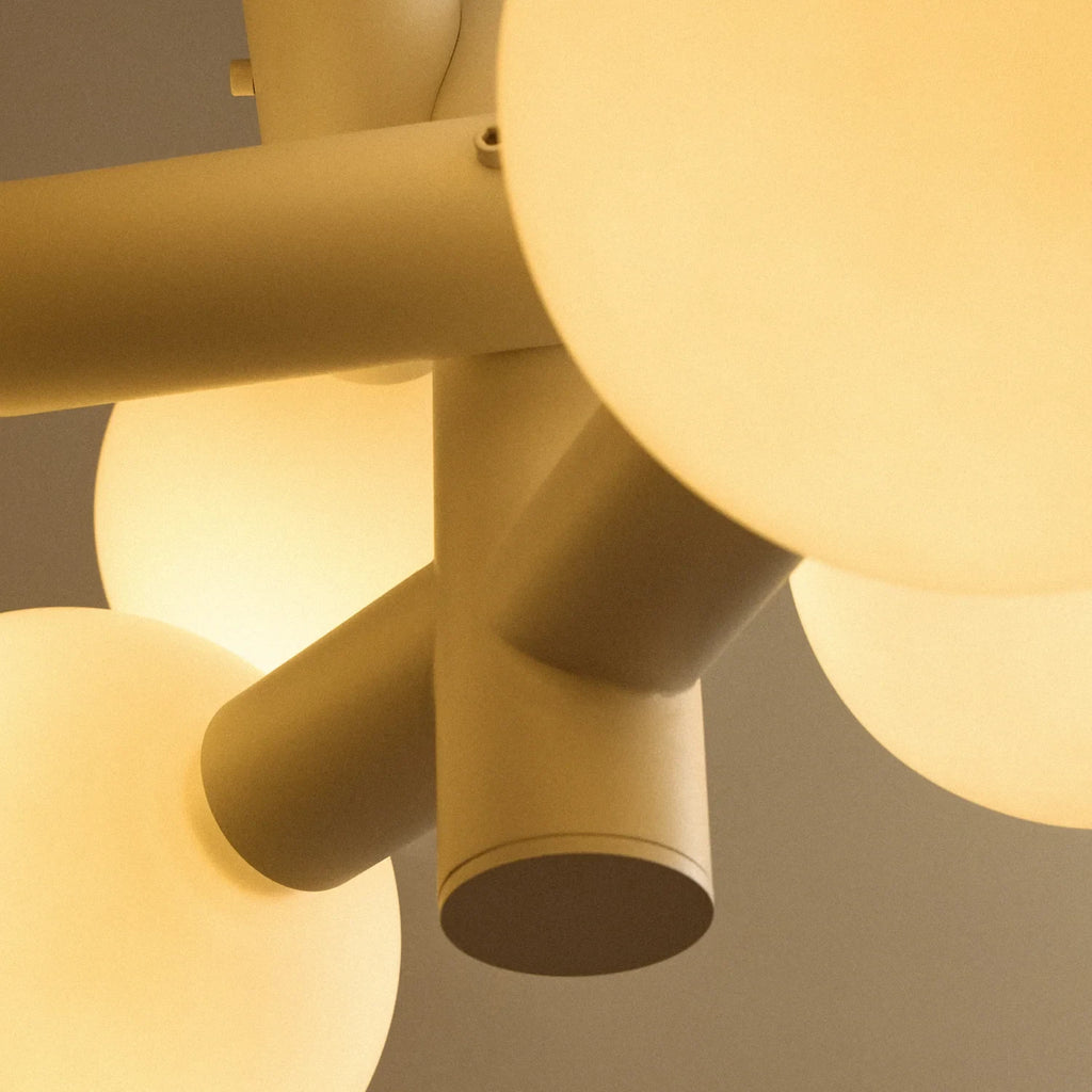 White steel globe cluster chandelier, detail of the steel cylinders and globes