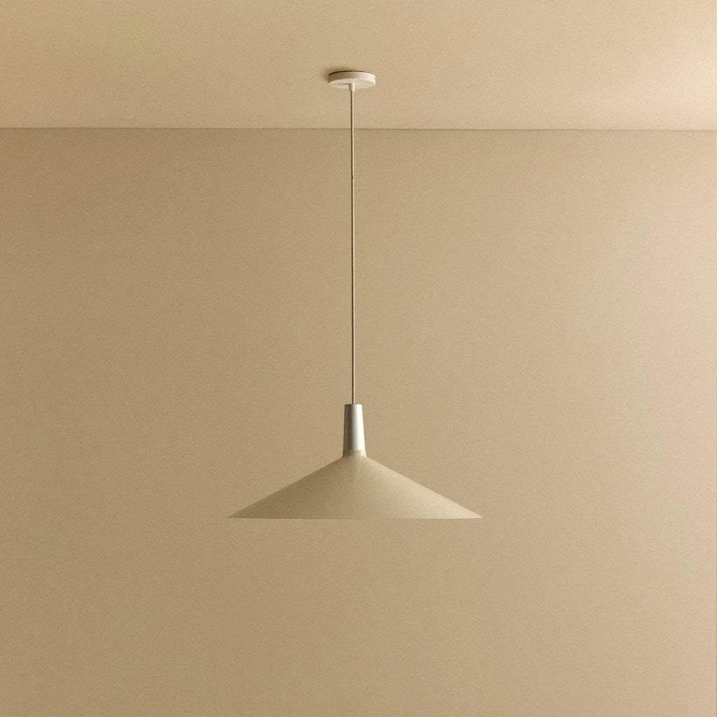 Large oyster white wide low-profile steel pendant, against a plain wall