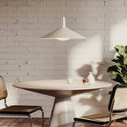 Large oyster white wide low-profile steel pendant, above a dining table