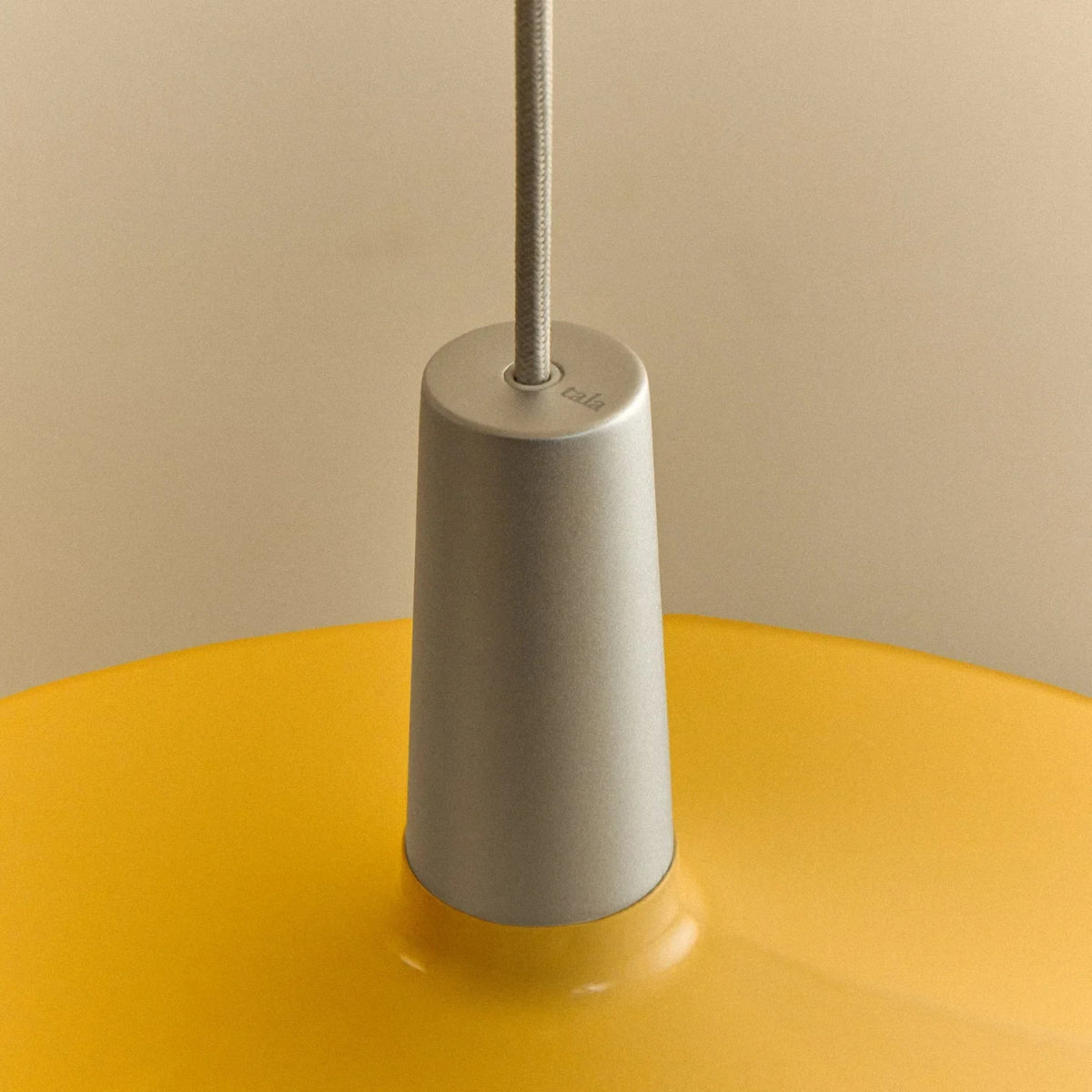Large yellow wide steel pendant with oval bulb, close-up of the holder and shade
